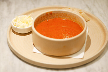 tomato soup in a bowl on table 