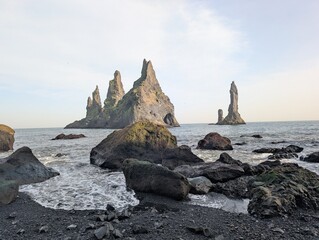 Rocks in the ocean along the black beach coast in Iceland