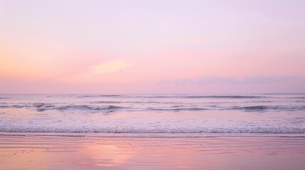 Fototapeta premium Soft pastel sunset painting the sky over a calm ocean beach, with gentle waves lapping the shore. The sky blends hues of pink, blue, and purple, while the water mirrors the serene colors, 