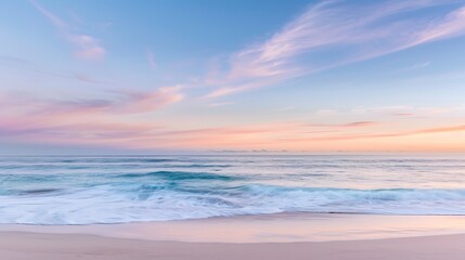 Naklejka premium Soft pastel sunset painting the sky over a calm ocean beach, with gentle waves lapping the shore. The sky blends hues of pink, blue, and purple, while the water mirrors the serene colors, 