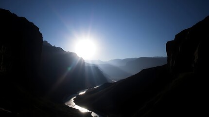 Sunburst over a shadowy canyon river