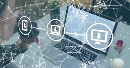 Mid-adult woman raising wine glass starting network linking icons showing technology connectivity - Powered by Adobe