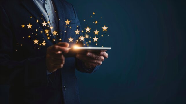 Businessman using a tablet with glowing stars for excellent customer reviews