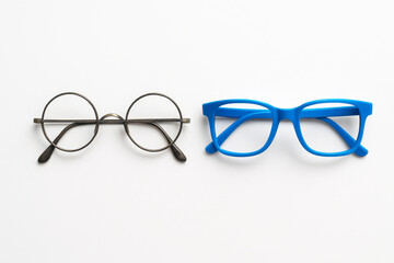 Fototapeta premium Round Metal Glasses and Blue Plastic Glasses on White Background