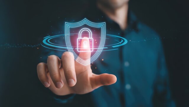 Hand touches digital shield with lock, symbolizing network security and protection.