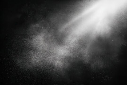 Floating dust particles captured in a black matte textured background with a beam of light enhancing the ethereal atmosphere during a quiet moment of reflection