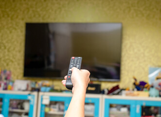 Hand pointing to tv screen set and turning it on or off select channel watching tv .TV Entertainment Concept