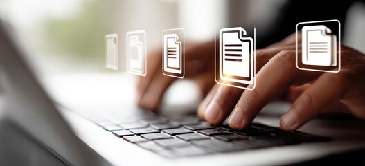 Hands typing on a laptop keyboard with document icons overlay