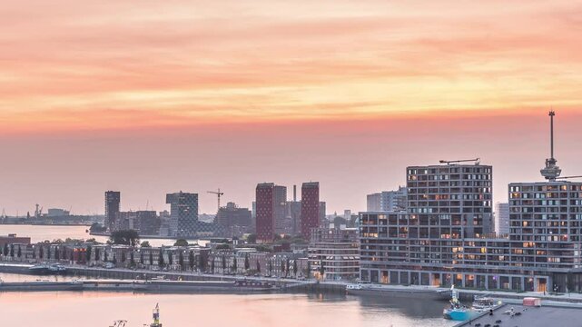 Panoramic aerial day to night transition timelapse of Katendrecht peninsula and Maashaven harbour in Rotterdam, The Netherlands. City skyline modern skyscrapers and traditional Dutch waterfront houses