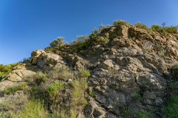 MIDDLE TOPANGA FORMATION AND VOLCANIC ROCKS / Dark gray sandstone of basaltic grains. top of Mount Hollywood Trail, Griffith Park, Los Angeles, California. Santa Monica Mountains.