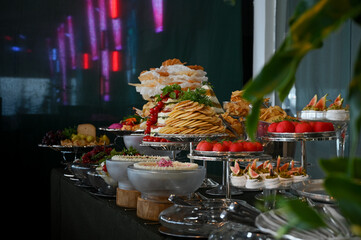 buffet table with utensils and cold dishes, birthday table setting, party table setting, table setting, dining table, banquet table setting