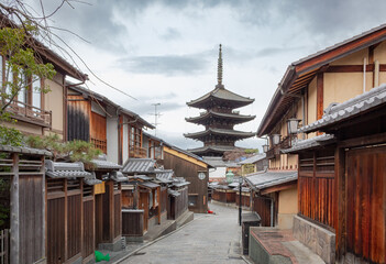 Giant wooden Five-story pagoda located along a traditional building filled street in Gion Kyoto Japan. Photo taken on a cloudy day