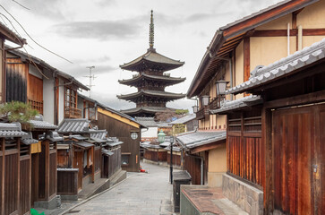 Giant wooden Five-story pagoda located along a traditional building filled street in Gion Kyoto Japan. Photo taken on a cloudy day