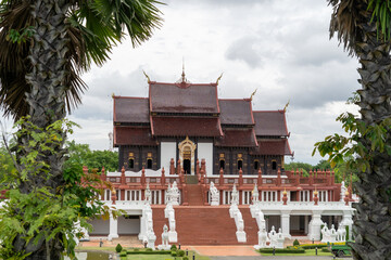 A large building with a white roof and red trim
