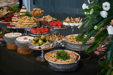 buffet table with utensils and cold dishes, birthday table setting, party table setting, table setting, dining table, banquet table setting