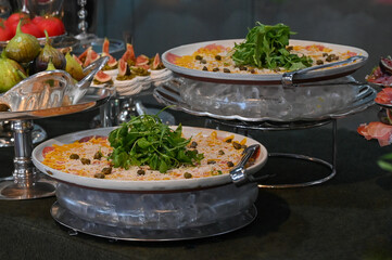 carpaccio , thin beef carpaccio with arugula and parmesan, gourmet meat appetizer with vinaigrette topping, elegant carpaccio platter served cold for events	