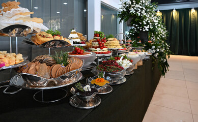 buffet table with utensils and cold dishes, birthday table setting, party table setting, table setting, dining table, banquet table setting