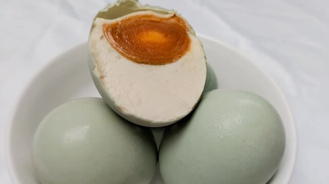 Selective focus. Salted Egg is a traditional dish from Brebes, Central Java, Indonesia. It is made from duck eggs that are salted and then boiled. Footage.
