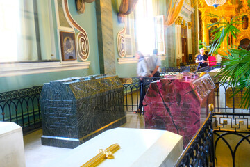 Inside St. Petersburg's Winter Palace, opulent halls boast dazzling chandeliers, gilded columns,...