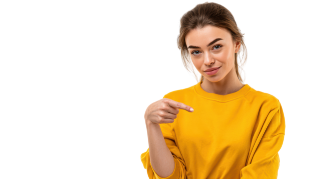 Smiling woman in a yellow sweater pointing to the side with a relaxed expression, white isolate background.