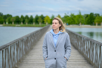 Blonde Woman Standing On Bridge