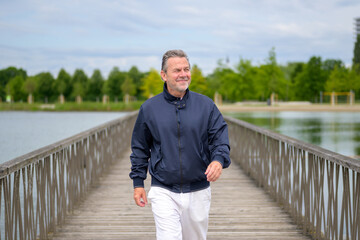 Senior Man Walking On Bridge