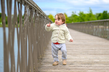 Toddler Walking On Wooden Bridge