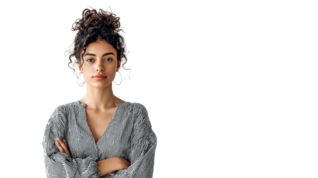 Confident young woman with curly hair, arms crossed, isolated on white background.