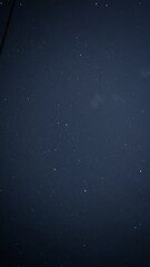 Starry night sky with scattered stars visible against a deep blue background.