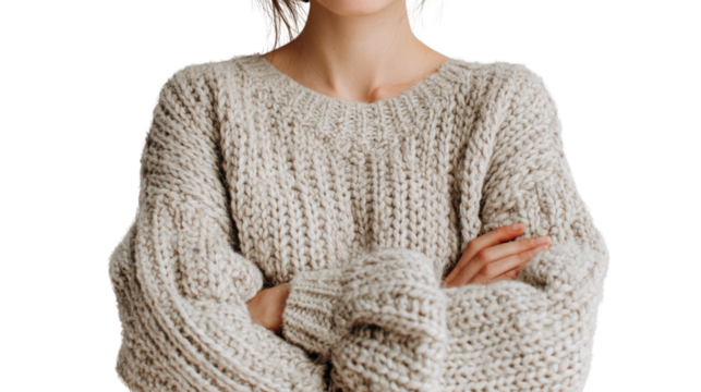 Woman in cozy sweater, arms crossed, thoughtful expression, white isolate background.