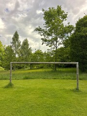Wooden goal post is in a grassy field