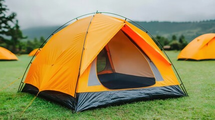 Candid Photos Capturing Realistic Moments Concept. Vibrant Orange Tent Set Against Green Grass in Scenic Outdoor Landscape with Mountains