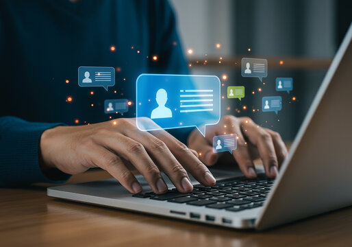 Person typing on laptop with glowing chat message icons - Powered by Adobe