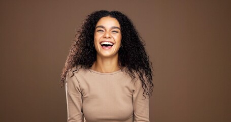 Natural, laugh and portrait of woman in studio for beauty, curly hairstyle and healthy texture....