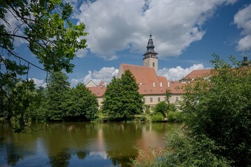 View of the Jesuit College and the tower of the Church of St. James the Greater across the Ulicky Pond in Telč