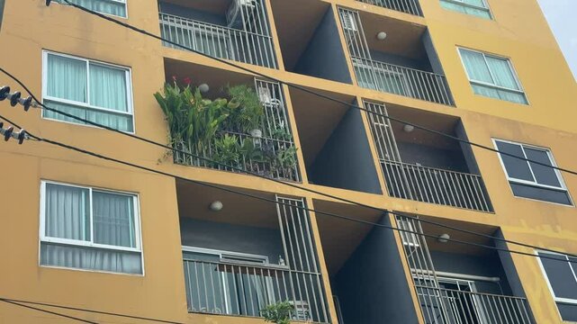 Residential condo windows patio daytime yellow wall.