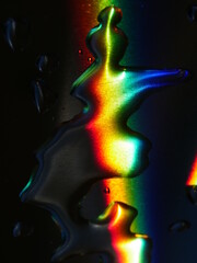 Rainbow is reflected in a puddle of water