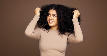 Mistake, hair and woman in studio with frizz problem, dry texture and split ends on brown...