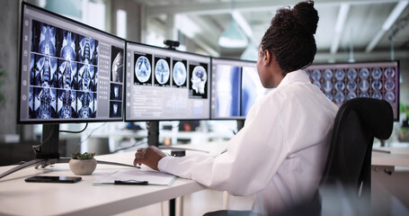African American Doctor Using Software To Scan Imaging