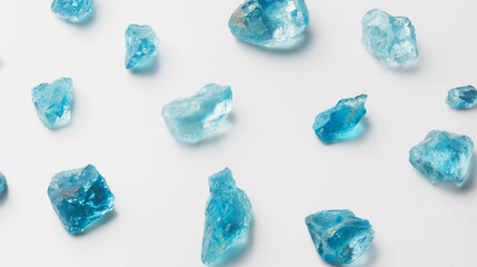 Minimal flat lay with raw blue topazes on white background