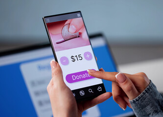 Female Financial Advisor Using Smartphone To Donate
