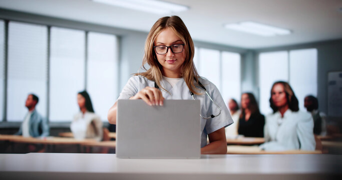 Medical Lecture With Young Female Nurse Using Laptop