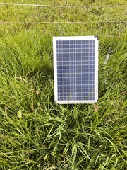 Solar panel is sitting on a grassy field