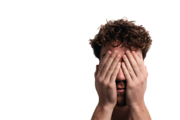 Man covering his eyes with hands, feeling stressed or overwhelmed.