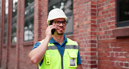 Skilled Builder In Uniform Discussing Progress Over Phone Call