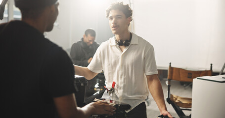 Men, director and talk with tablet backstage for feedback, script update and planning for scene....