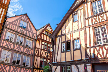 Historic half-timbered houses showcase architectural beauty in Rouen, France on a clear sunny day