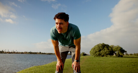 Tired, active and man for fitness outdoor from running, sports exercise and workout break....