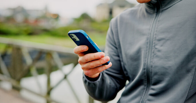 Exercise, break and hands with phone on bridge for fitness app, check stats or workout performance. Runner, person and smartphone in nature for cardio progress, track running speed and training timer
