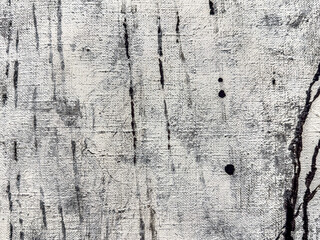 textured white canvas background with vertical black brush strokes. macro shot.